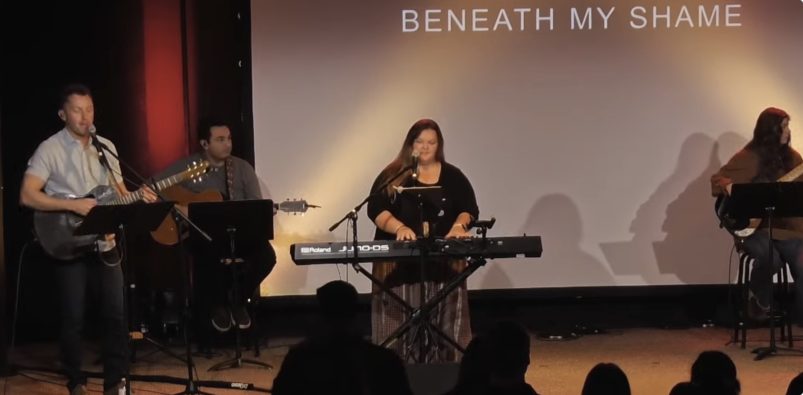 Bobby Azad playing acoustic guitar with the worship team at New Life Fellowship Church in Aberdeen, South Dakota